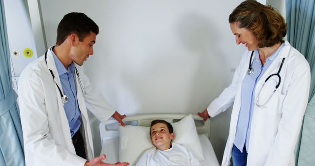 Doctors Assisting Young Patient in Hospital Bed - Download Free Stock Images Pikwizard.com