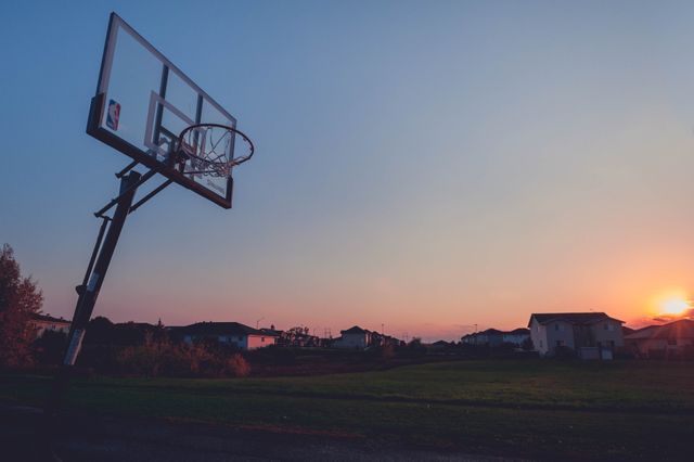 Outdoor Basketball Hoop at Sunset in Suburban Neighborhood - Download Free Stock Photos Pikwizard.com