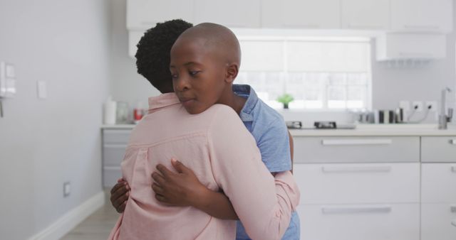 Child Embracing Parent in Modern Kitchen - Download Free Stock Images Pikwizard.com