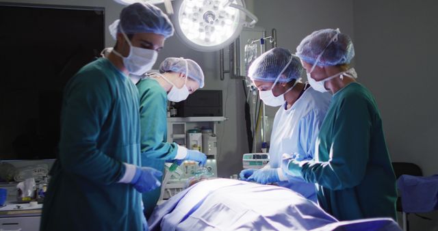 Image of diverse group of surgeons operating on patient in operating theatre. Hospital, medical and healthcare services.