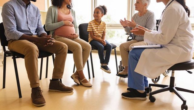 Multigenerational family participating in prenatal and eldercare consultation with clinician