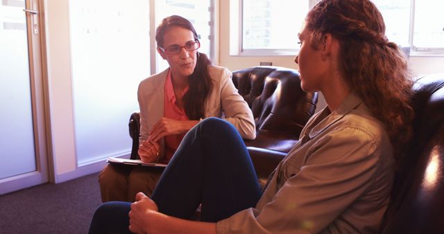 Therapist counseling young woman in cozy office - Download Free Stock Images Pikwizard.com