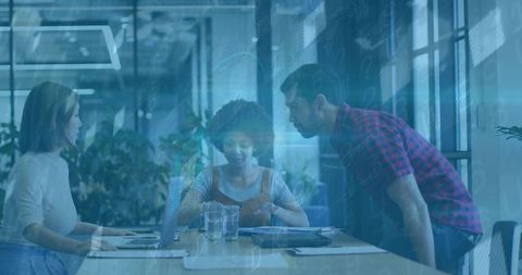 Diverse Team Analyzing Data and Strategies in Modern Office