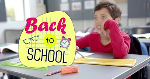 Curious student resting chin at desk with back to school graphic and supplies