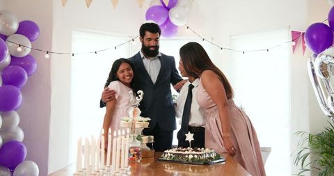 Family celebrating special occasion with cake and decorations