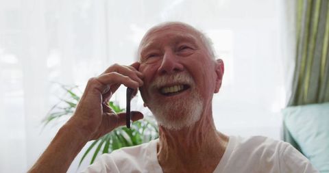 Elderly Man Enjoying Phone Call at Retirement Home