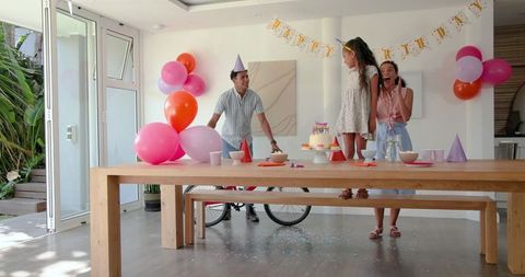 Joyful Family Birthday Celebration with Balloons and Cake