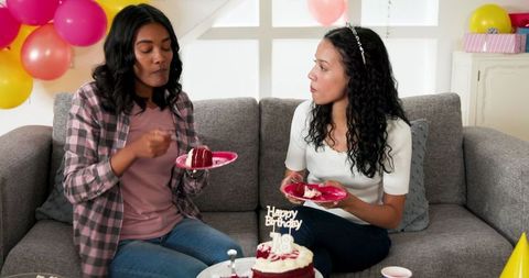 Birthday celebration in living room with cake and friends