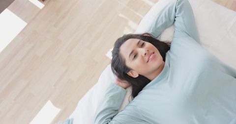 Relaxed Woman Enjoying Natural Light at Home