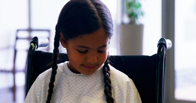 Young Girl in Hospital Gown Sitting in Wheelchair - Download Free Stock Images Pikwizard.com