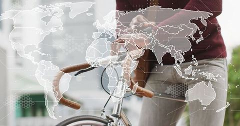 Urban Cyclist with World Map Overlay Embracing Global Connectivity