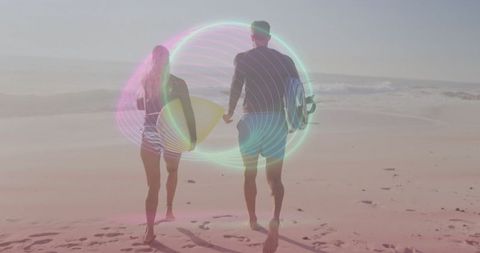 Surfers Walking on Seashore Under Vibrant Neon Lights