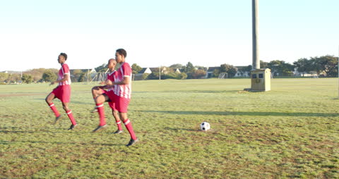 Soccer Players Warming Up and Practicing in Morning Sun