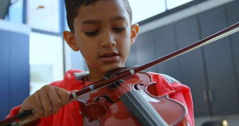 Young Boy Focused on Playing Violin in School Classroom - Download Free Stock Images Pikwizard.com