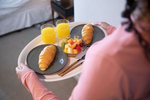 Elegant Breakfast Tray with Croissants and Juice in Cozy Bedroom
