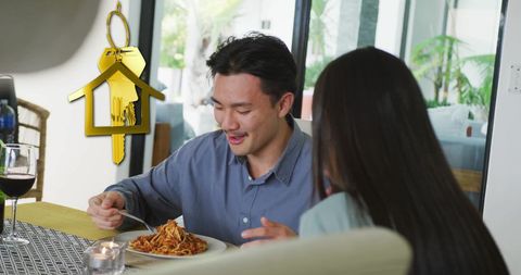 Couple Enjoying Meal at Home with Gold House Key Symbolizing Ownership - Download Free Stock Images Pikwizard.com
