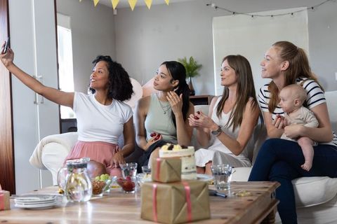 Diverse Female Friends Celebrating with Selfie in Cozy Living Room