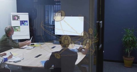 Business team collaborating at glass-partitioned meeting table with digital network overlay