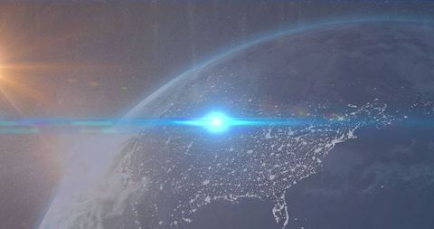 Bright blue burst illuminating earth's hemisphere with sunflare