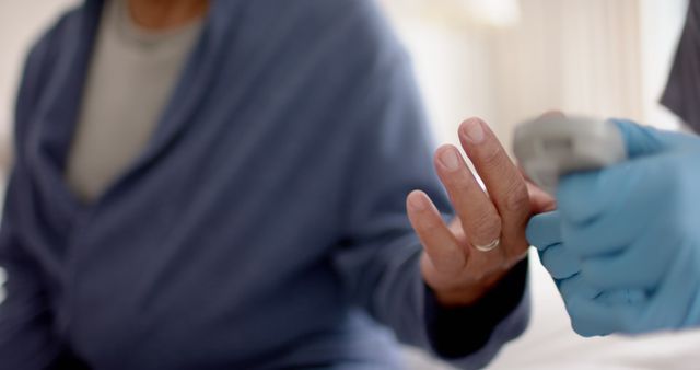 Elderly man receiving healthcare assistance with pulse oximeter - Download Free Stock Images Pikwizard.com