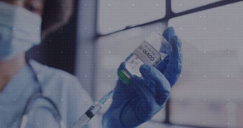 Healthcare Worker Preparing COVID-19 Vaccine Syringe in Clinic