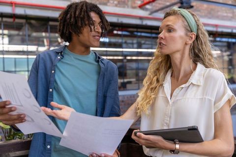 Diverse Coworkers Collaborating on Business Plans in Modern Office