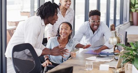 Diverse Team Celebrating in Modern Office Environment