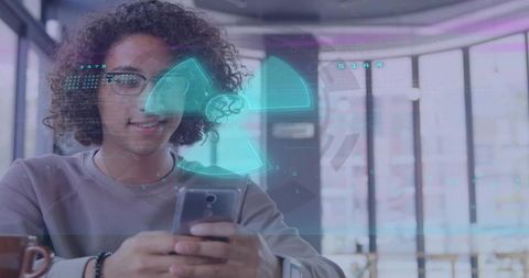 Young man using smartphone viewing augmented reality radiation interface in urban coworking cafe