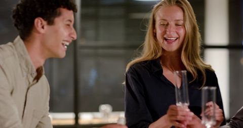 Colleagues Sharing Drinks at Office Night Gathering Enjoying Celebration