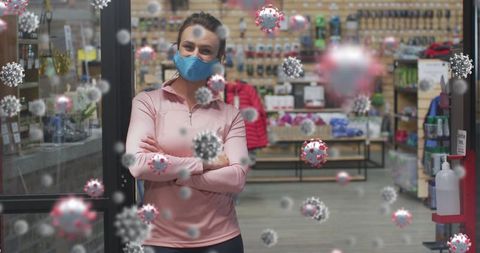 Woman in sports shop with covid-19 safety precautions