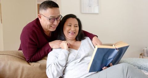 Aging Couple Enjoying a Book Together at Home