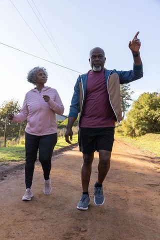 Senior African American Couple Walking Outdoors on Rustic Path