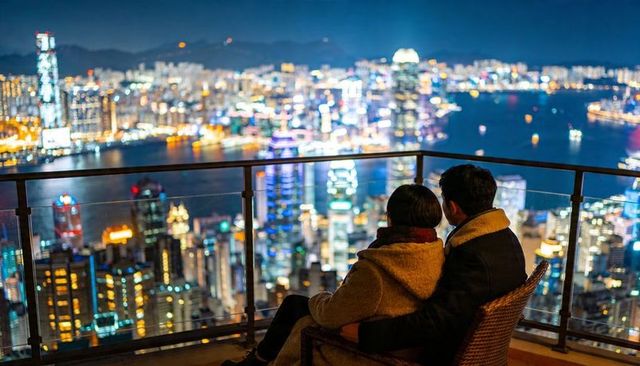 Couple embracing on rooftop balcony overlooking vibrant neon harbor skyline at night