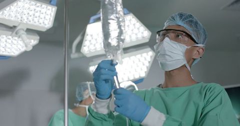 Medical Professional Preparing IV Bag in Operating Room