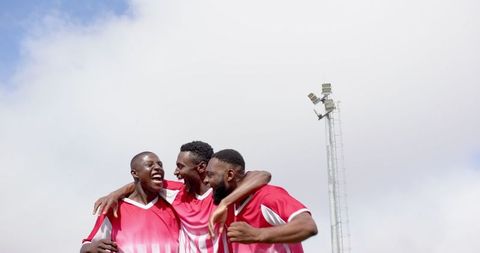 Joyful Teammate Celebration Under Floodlight