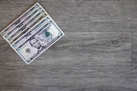 Five Dollar Bills on Gray Wooden Surface