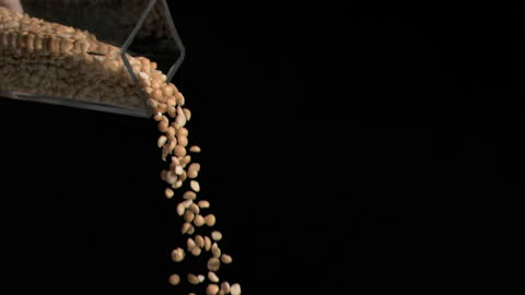 Peanuts Flowing from Glass Jar
