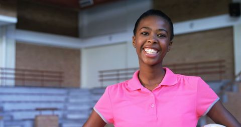 Confident Female Volleyball Player Smiling on Court