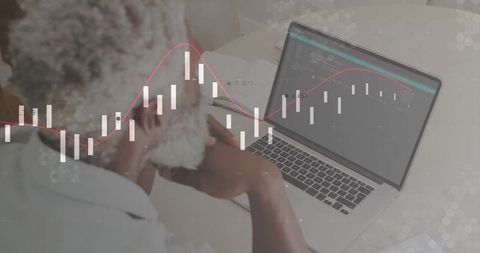 Professional analyzing stock market data on laptop desk setup