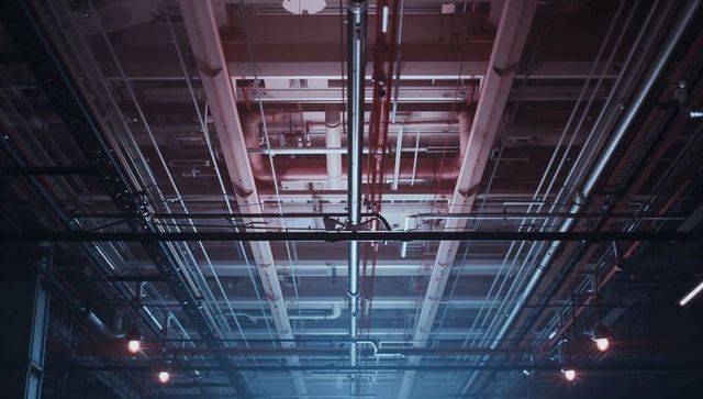 Complex network of industrial ceiling pipes and conduits