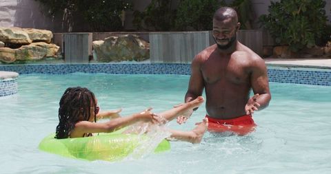 African American Father and Daughter Enjoying Pool Fun