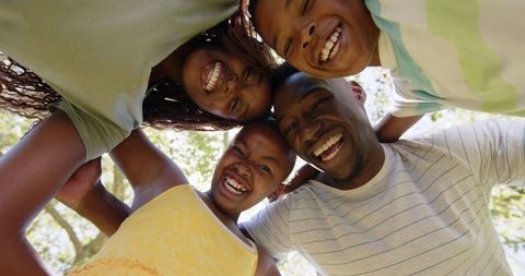 Happy Family Bonding Outdoors Under Sunny Sky