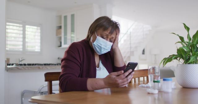 Senior Woman in Face Mask Looking at Smartphone Feeling Unwell - Download Free Stock Images Pikwizard.com