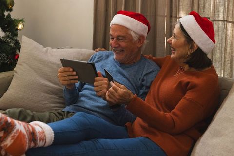 Senior Couple Enjoys Online Shopping During Festive Holidays