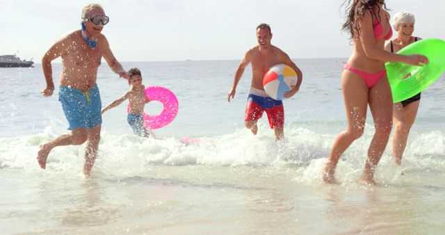 Multi-Generational Family Enjoying Beach Fun in Shallow Waters - Download Free Stock Images Pikwizard.com