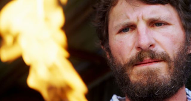 Man with Beard Concentrating on Flame in Outdoor Setting - Download Free Stock Images Pikwizard.com