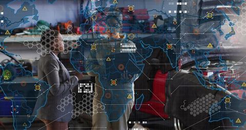 Two women discussing automotive repair strategy in workshop using digital data overlay