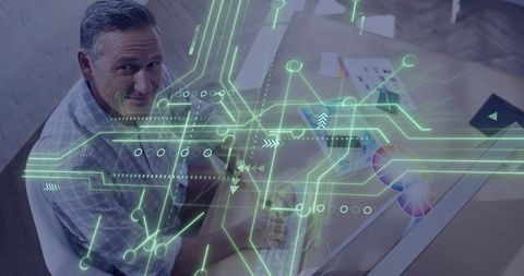 Designer Typing with Neon Augmented Reality Circuit Overlay on Creative Workspace