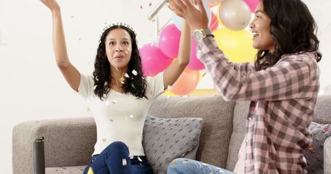 Joyful Celebration with Party Poppers and Colorful Balloons