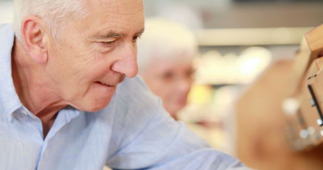 Senior Man Browsing Products at Grocery Store - Download Free Stock Images Pikwizard.com